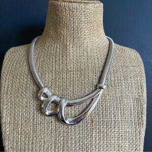 Elegant silver tone omega necklace.